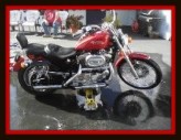 Motorcycle being washed by Fifty Dollar Deatil.